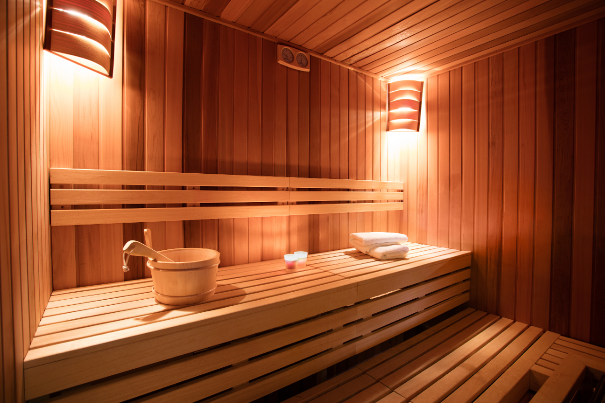 Modern sauna interior with wooden benches and soft lighting.