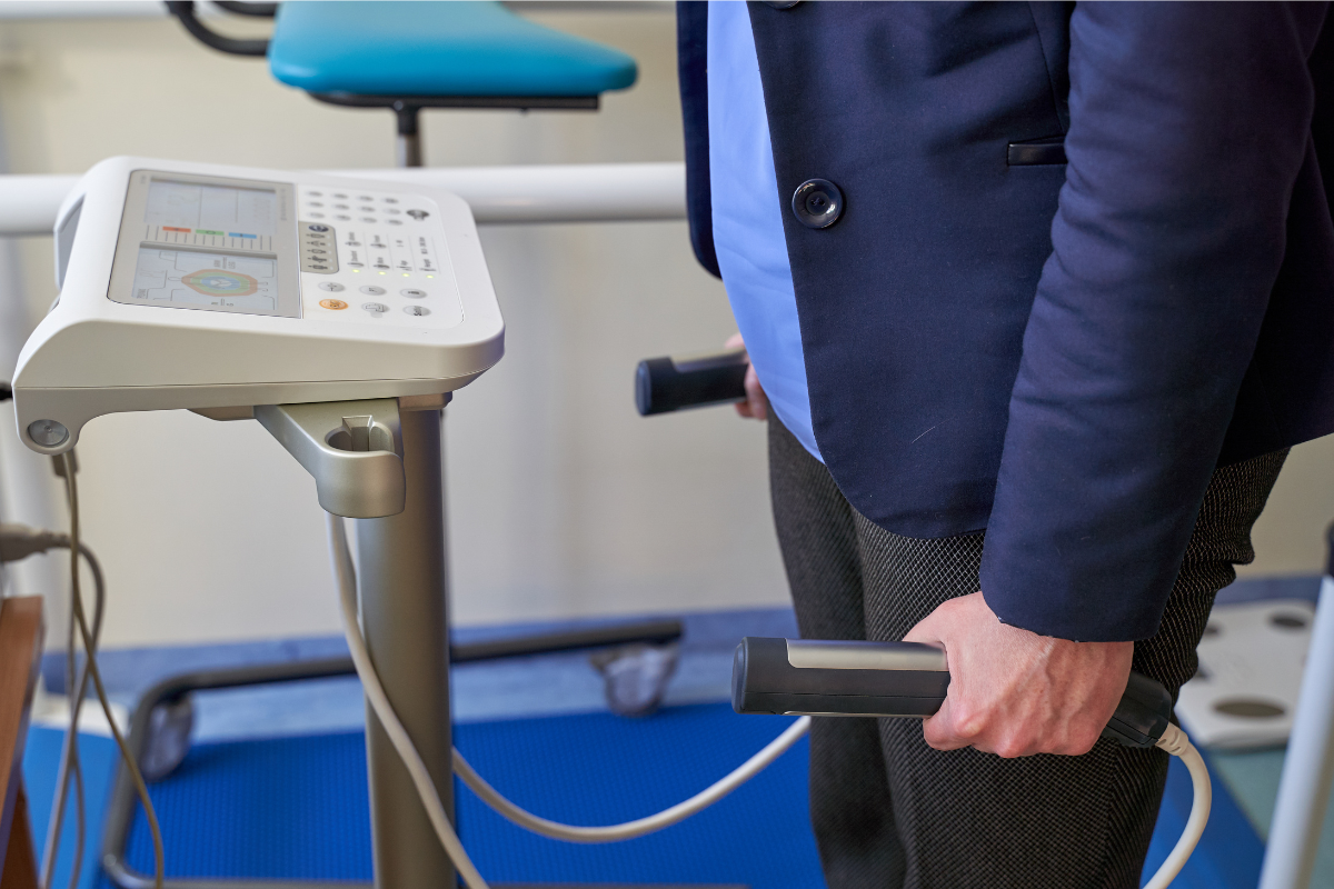 Person using a Bioelectrical Impedance Analysis (BIA) device to measure body composition.