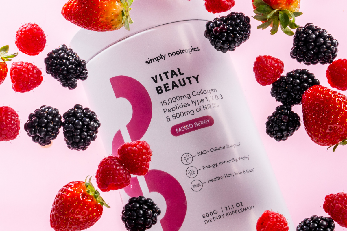 Vital Beauty Collagen tub surrounded by fresh strawberries, raspberries and blackberries.